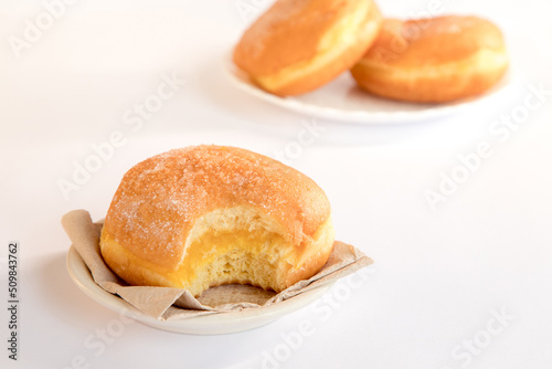 Bolas de Berlim, Berliner or donuts filled with egg jam, a very popular dessert in Portuguese pastry shops. photo