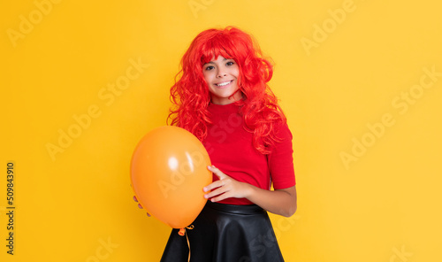 girl smile with party balloon on yellow background © be free