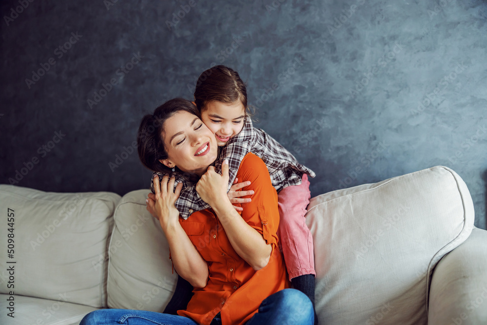 Smiling daughter hugging her mother and showing her a lot of love. Smiling daughter hugging her mother and showing her a lot of love.