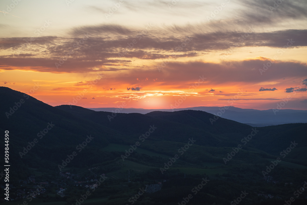 Beautiful sunset over the green hills. High quality photo.