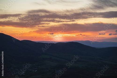 Beautiful sunset over the green hills. High quality photo. © Munka