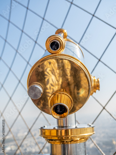 Close up of brass telescope on top of Eiffel Tower.