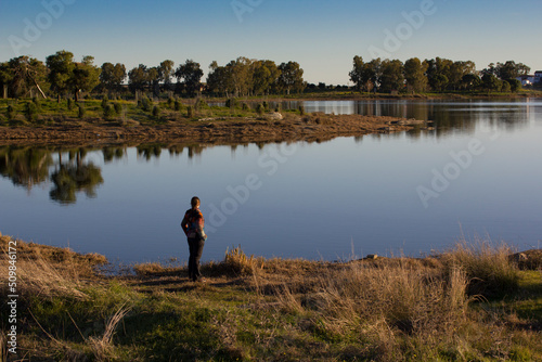 Person looking out over a tranquil lake
