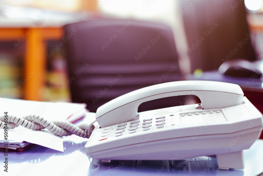 Office telephone on desk,telephone on table with blur office background.. Office telephone on desk,telephone on table with blur office background..