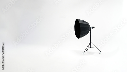 One studio lights of softbox and octobox stand against background of white cyclorama in photostudio