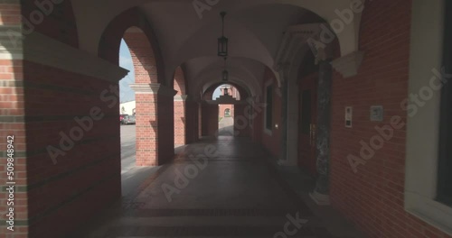 A long walk through the archways of a building's covered cloister. photo