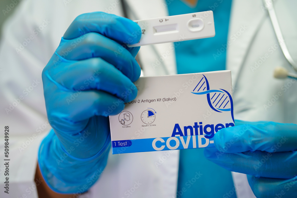 doctor in ppe holding Antigen Rapid Test kit ATK in hospital. doctor in ppe holding Antigen Rapid Test kit ATK in hospital.