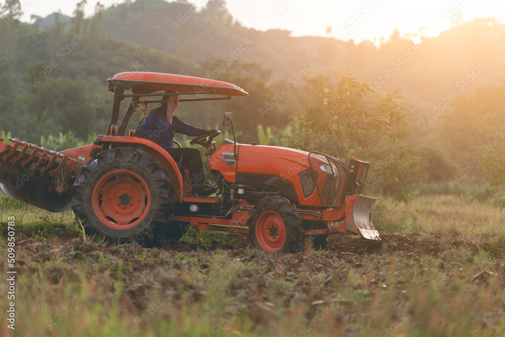 farm tractor with driver plowing to fill the soil for cultivation farm tractor with driver plowing to fill the soil for cultivation
