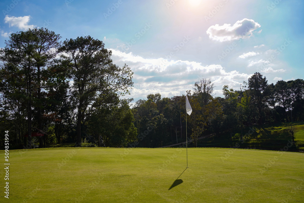 Obraz premium View of Golf Course with beautiful putting green. Golf course with a rich green turf beautiful scenery.
