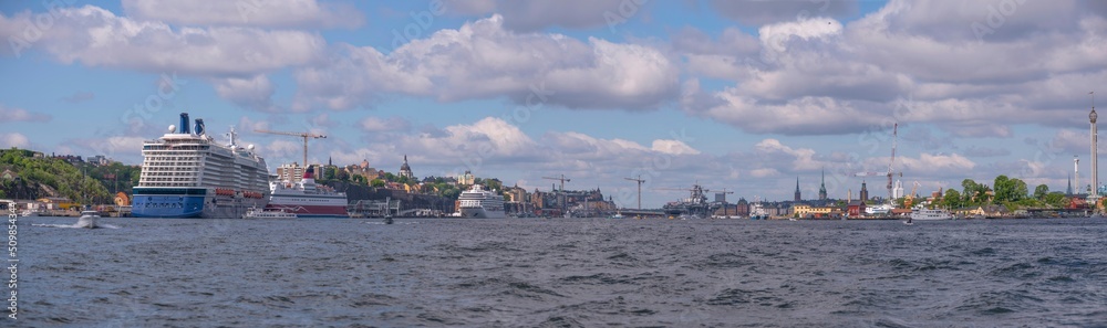 Panorama view with small passenger explorer and a cruise ship at a pier in the harbor a sunny summer day in Stockholm