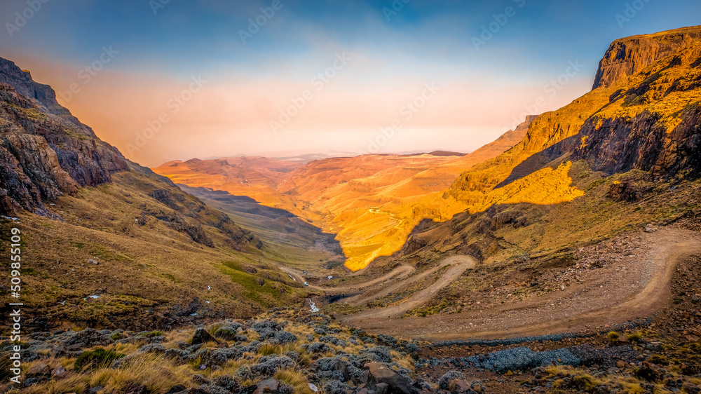 Obraz premium Valley and winding road over mountains from South Africa to Lesotho over Sani Pass.