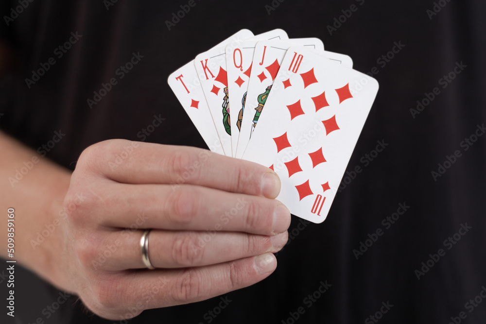 Male hands hold a deck of cards and show tricks. The photographer is ...