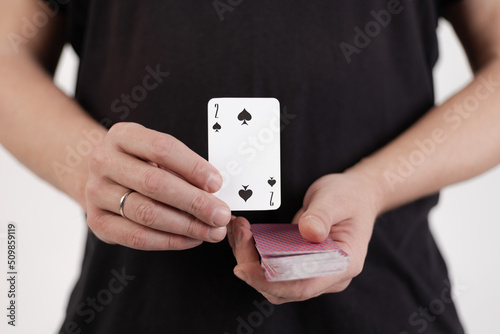 Male hands hold a deck of cards and show tricks.
The photographer is the author of the design of playing cards, which is written in the release of the property. photo