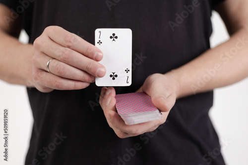 Male hands hold a deck of cards and show tricks.
The photographer is the author of the design of playing cards, which is written in the release of the property. photo