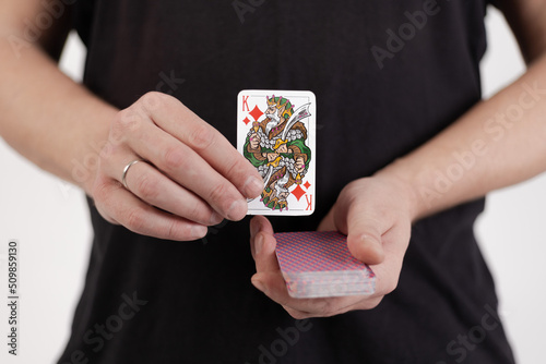Male hands hold a deck of cards and show tricks.
The photographer is the author of the design of playing cards, which is written in the release of the property. photo