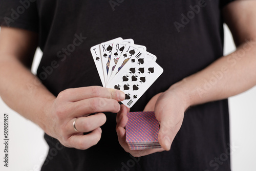 Male hands hold a deck of cards and show tricks.
The photographer is the author of the design of playing cards, which is written in the release of the property. photo