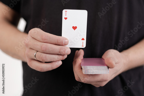 Male hands hold a deck of cards and show tricks.
The photographer is the author of the design of playing cards, which is written in the release of the property. photo