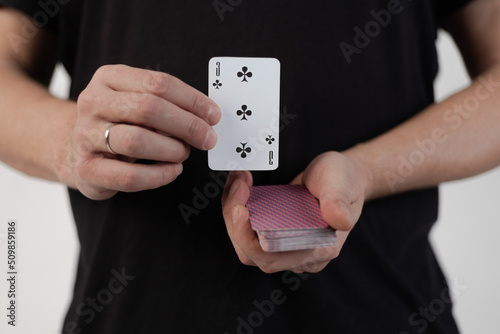 Male hands hold a deck of cards and show tricks.
The photographer is the author of the design of playing cards, which is written in the release of the property. photo