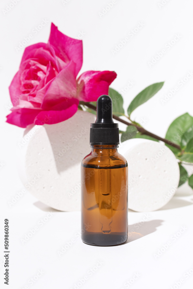 Glass dropper bottles and podium with rose flower. Hyaluronic acid oil, serum with collagen and peptides skin care product. Mockup packaging, cosmetic design branding Glass dropper bottles and podium with rose flower. Hyaluronic acid oil, serum with collagen and peptides skin care product. Mockup packaging, cosmetic design branding