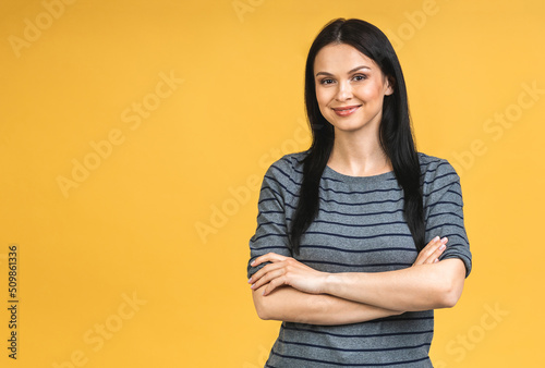 Obraz na plátně Portrait of happy smiling brunette girl in casual isolated over yellow background