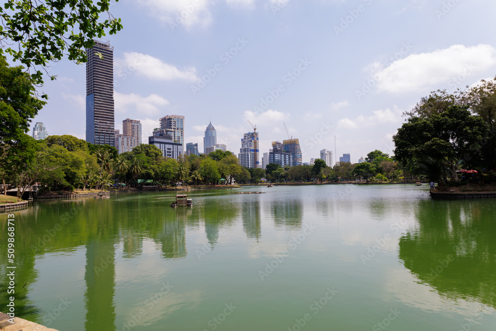 Lake in City Park under Skyscrapers at the day. Lumpini Park in Bangkok, Thailand