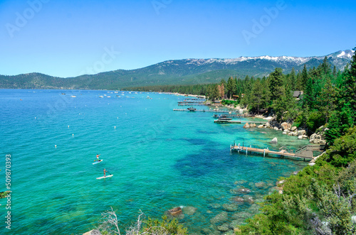 lake in the mountains  lake tahoe during summer  summer lake  summer activities on lake  stand up paddle boarding on lake  blue water