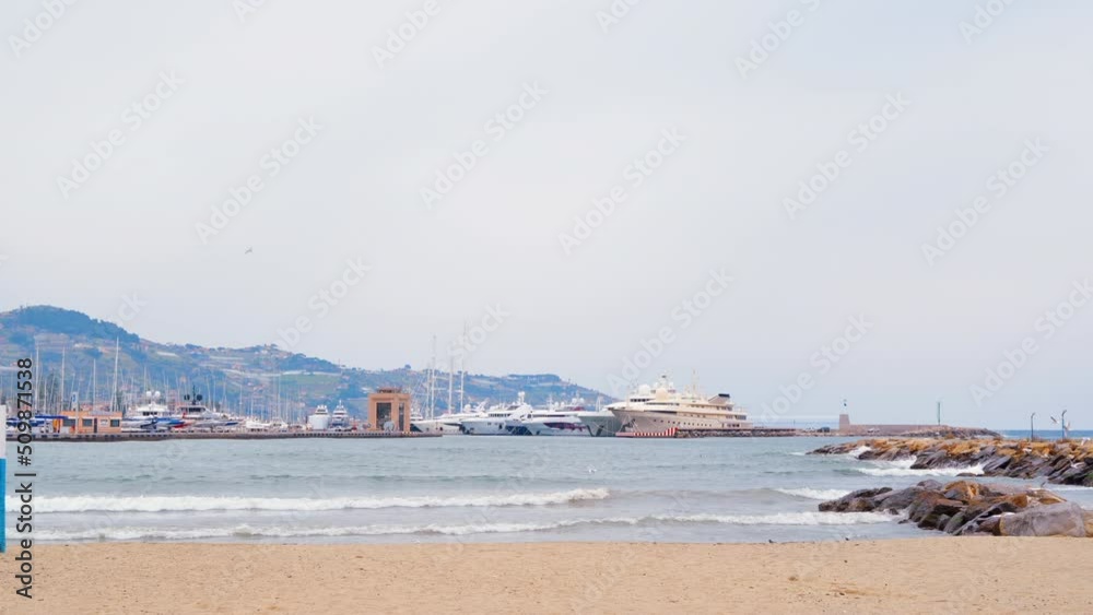 Mediterranean sea port with multiple moored yachts and boats in Sanremo, Italy. Cloudy sky Mediterranean sea port with multiple moored yachts and boats in Sanremo, Italy. Cloudy sky