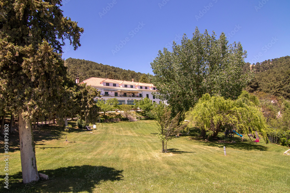 The exterior of the Hotel Parador De Cazorla, located in the Sierra de Cazorla. Surrounded by hills and nature.