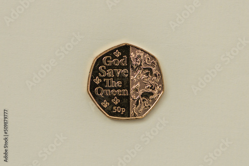Collectable gold plated 50 pence coin isolated on light background. photo