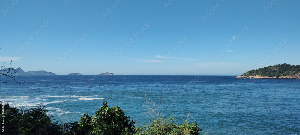 Fototapeta premium stone granite mineral hill wall cliff island forest sea ocean beach wave foam water blue sky leaf bush tree flower fruit horizon high landscape rio de Janeiro travel freighter ship vessel cargo contai