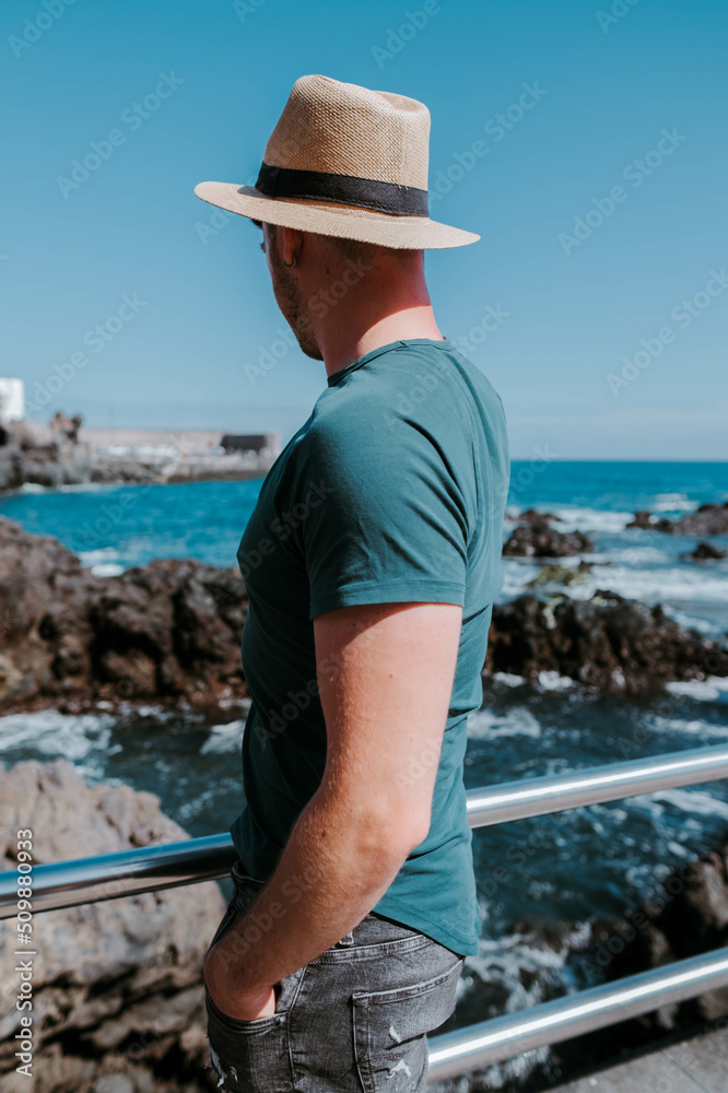 Man looking at the horizon in the beach