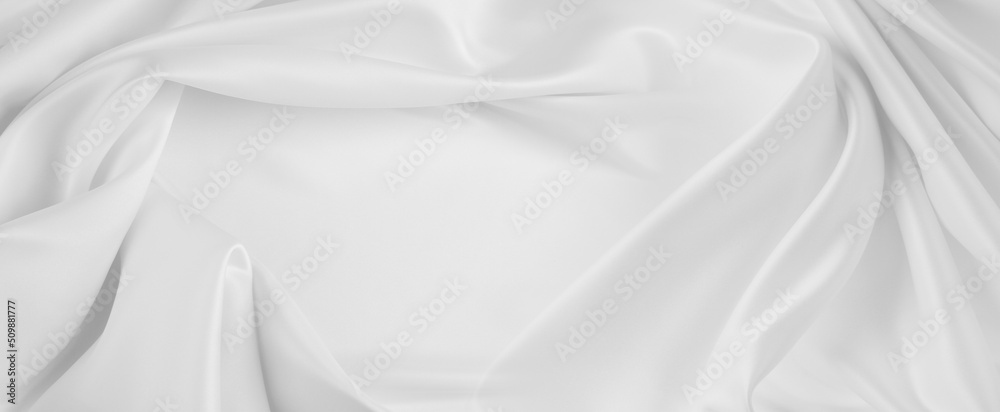 Close-up of rippled white silk fabric texture.
Copy space