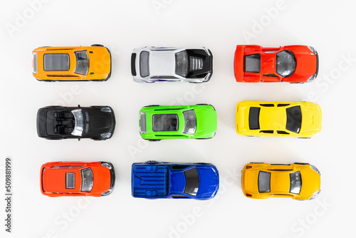 Colorful toy cars on white background, close up, top view. photo