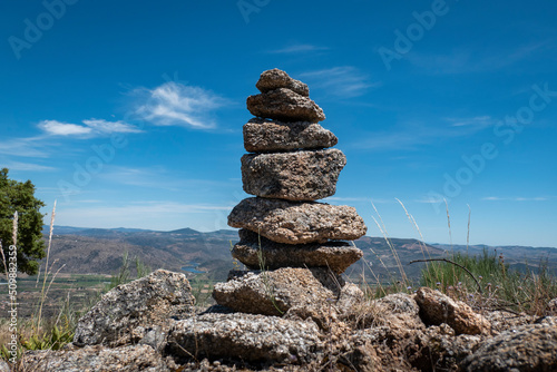 Pirâmide de pedras sobre algumas rochas junto ao baloiço do sobreiro em Castedo, Torre de Moncorvo, Portugal photo