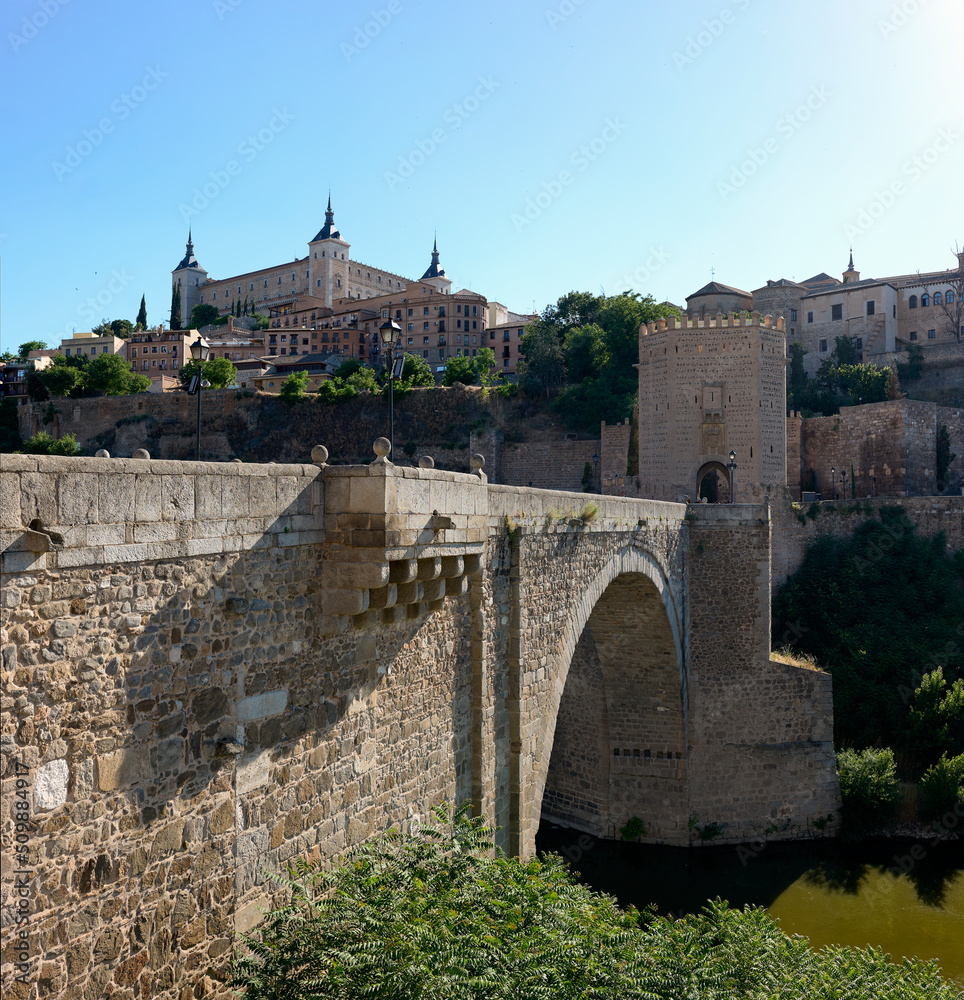 The Alcantara bridge, with the Alcazar of Toledo in the background. Castilla La Mancha, Spain.