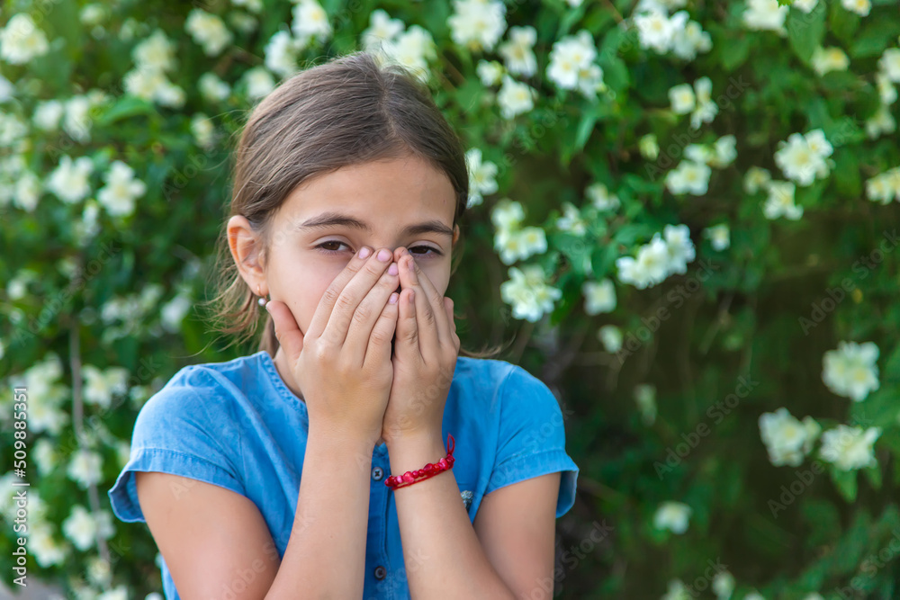 The child is allergic to flowers. Selective focus. The child is allergic to flowers. Selective focus.