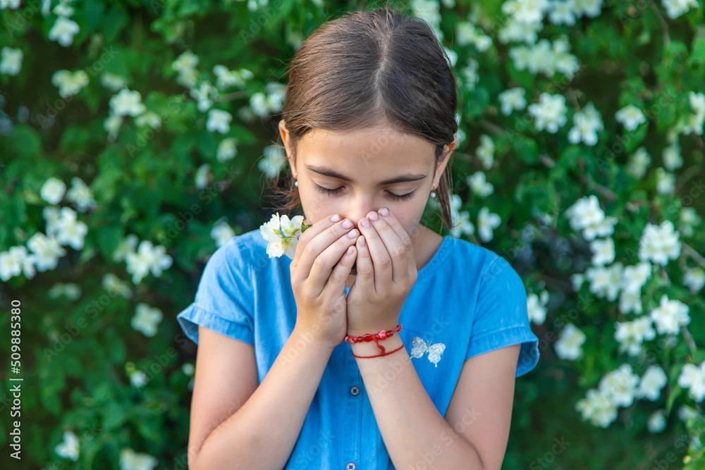 The child is allergic to flowers. Selective focus. The child is allergic to flowers. Selective focus.