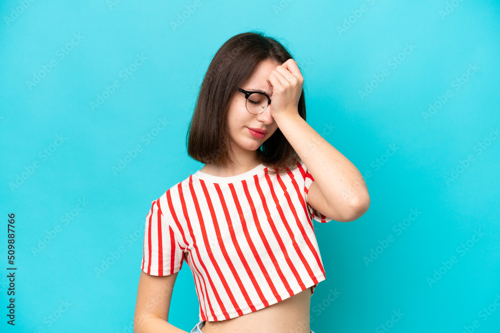 Young Ukrainian woman isolated on blue background with headache Young Ukrainian woman isolated on blue background with headache
