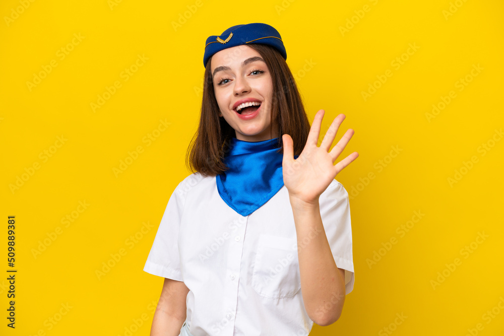 Airplane stewardess Ukrainian woman isolated on yellow background counting five with fingers Airplane stewardess Ukrainian woman isolated on yellow background counting five with fingers