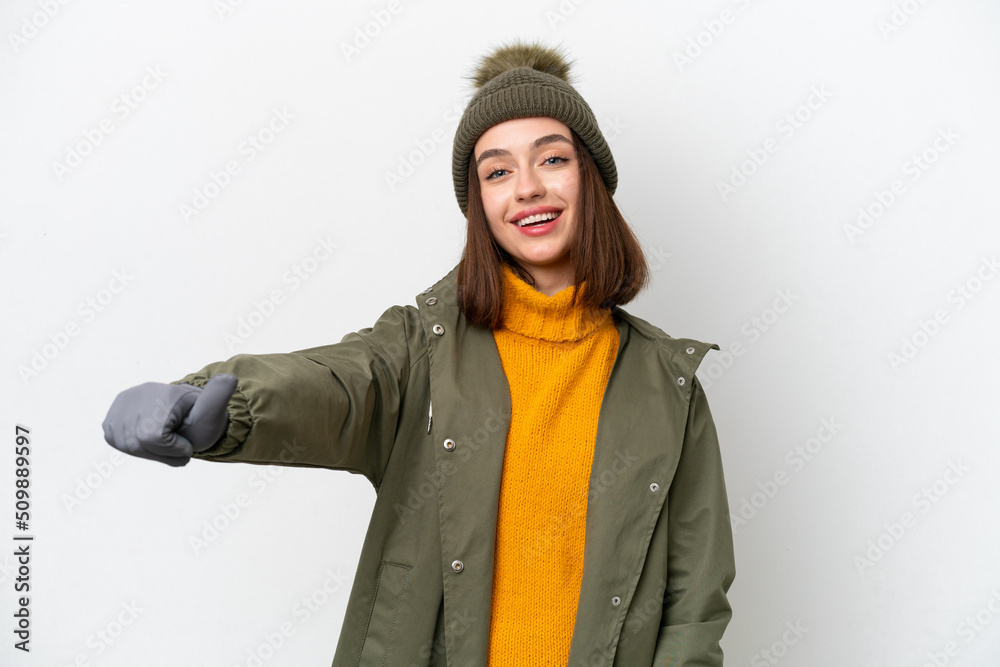 Young Ukrainian woman wearing winter jacket isolated on white background giving a thumbs up gesture Young Ukrainian woman wearing winter jacket isolated on white background giving a thumbs up gesture