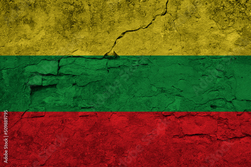 Patriotic cracked wall background in colors of national flag. Ghana