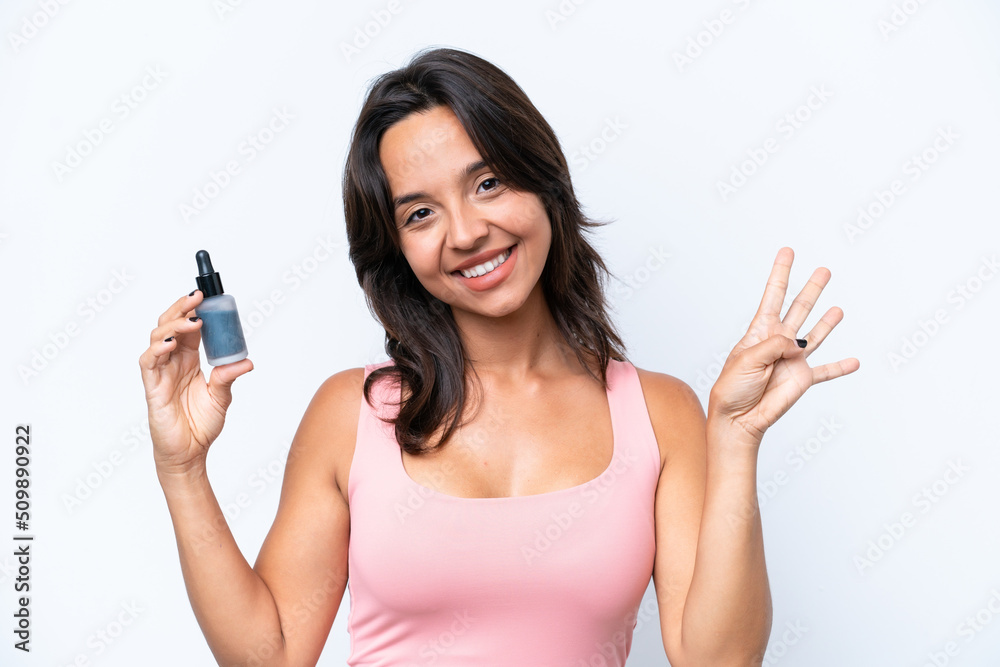 Young hispanic woman holding serum isolated on white background happy and counting four with fingers Young hispanic woman holding serum isolated on white background happy and counting four with fingers