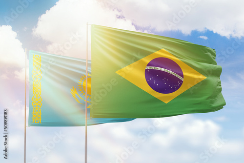 Sunny blue sky and flags of brazil and kazakhstan