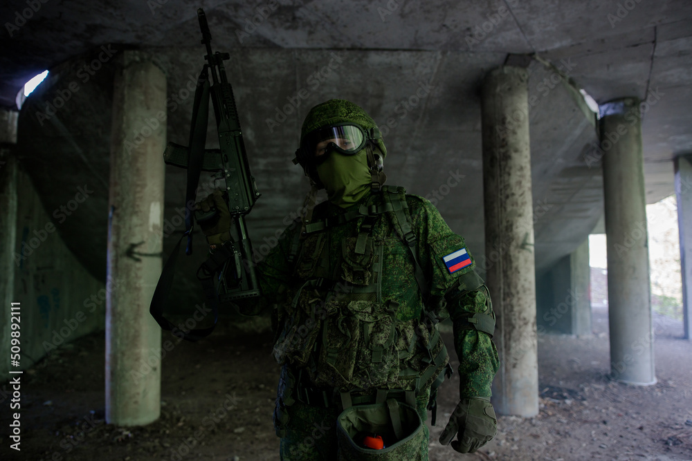 Russian military soldier in uniform holding up his weapon Russian military soldier in uniform holding up his weapon