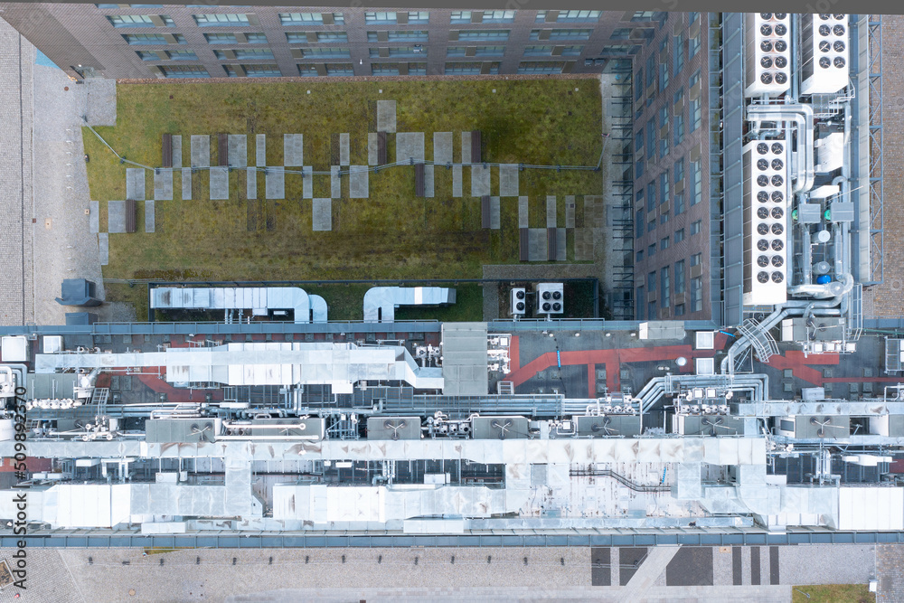 Air conditioning system on the roof of the building, advanced air conditioning and ventilation system, aerial view down the roof of the house, many different ventilation ducts Air conditioning system on the roof of the building, advanced air conditioning and ventilation system, aerial view down the roof of the house, many different ventilation ducts
