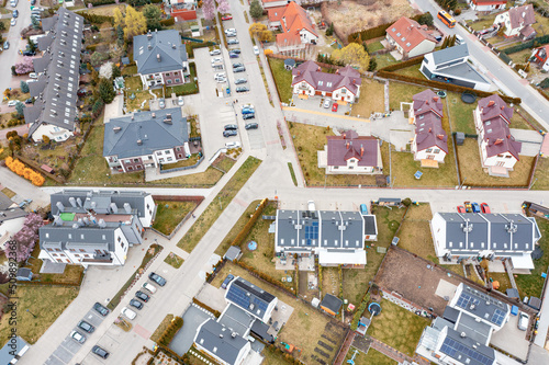 Aerial view of a densely built-up residential area with detached houses located in new private neighborhoods.