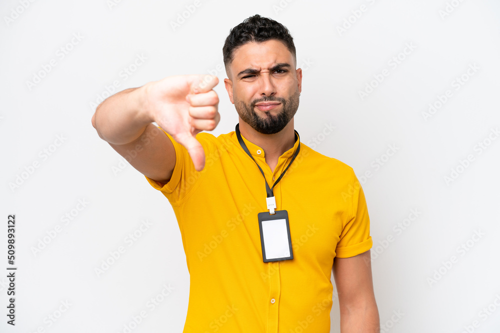Young Arab man with ID card isolated on white background showing thumb down with negative expression