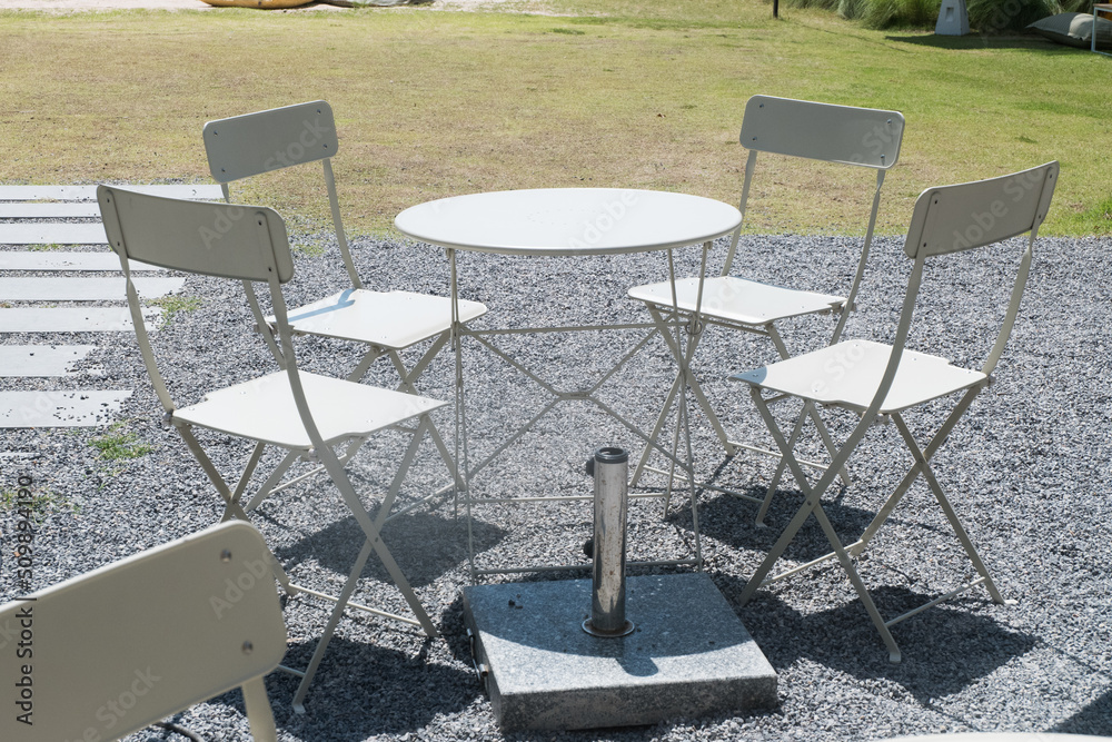 Empty white table and chair in garden. Empty white table and chair in garden.