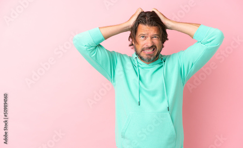 Senior dutch man isolated on pink background doing nervous gesture © luismolinero
