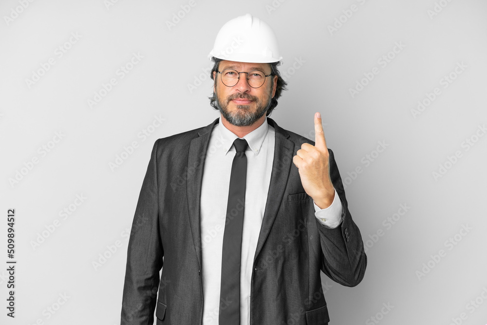 Young architect man with helmet over isolated background pointing with the index finger a great idea